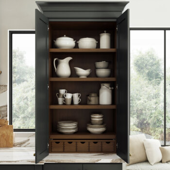 A counter-sitting larder cabinet for general pantry and dishware storage in the kitchen with apothecary drawers.